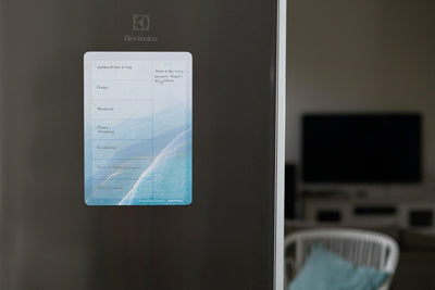 Electrolux refrigerator with a weekly A4 Whiteboard Planner showing a beach scene.